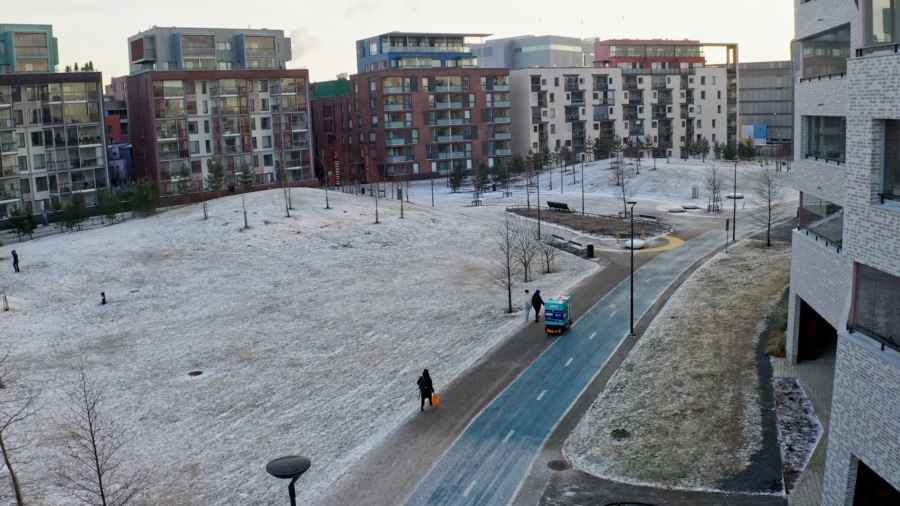 LMAD's robot in Helsinki, near a park covered in snow and appartment buildings