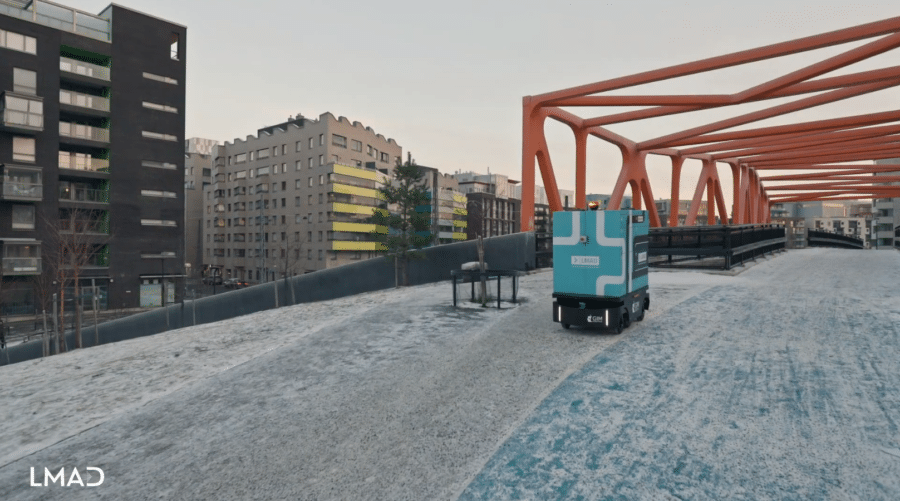 LMAD's robot on the streets of Helsinki, next to an orange bridge
