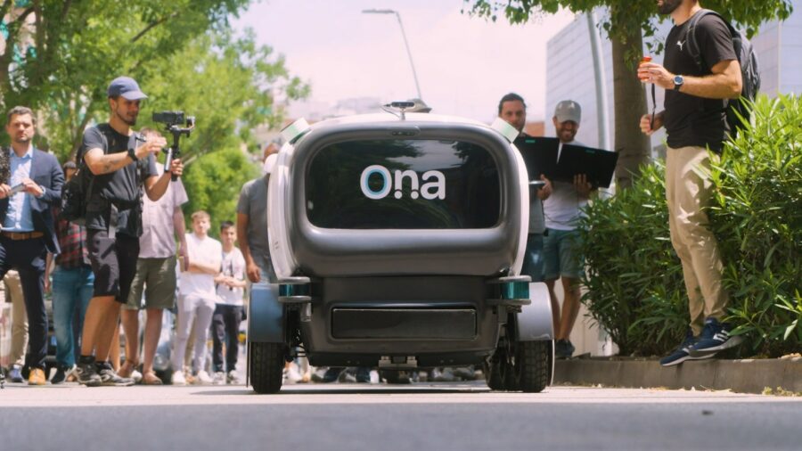 ONA riding on the streets of Barcelona surrounded by people