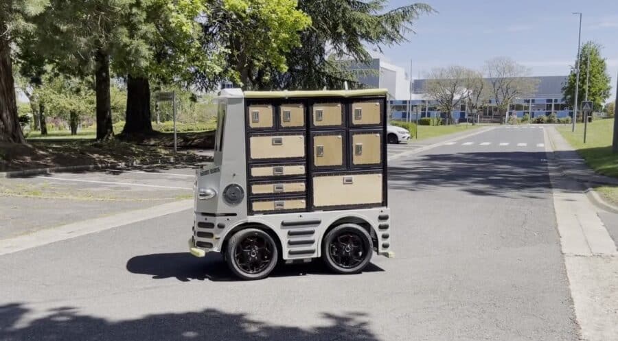 A robot on a paved road, making a turn; lockers visible